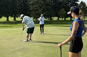 golfers on putting green 300 x 198